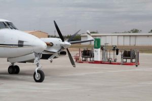 Airplane in front of fuel pumps